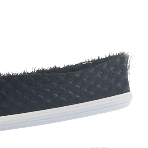 Close-up of a black rubber door seal strip on a white background