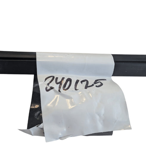 White paper with handwritten numbers attached to a black metal bar on a white background