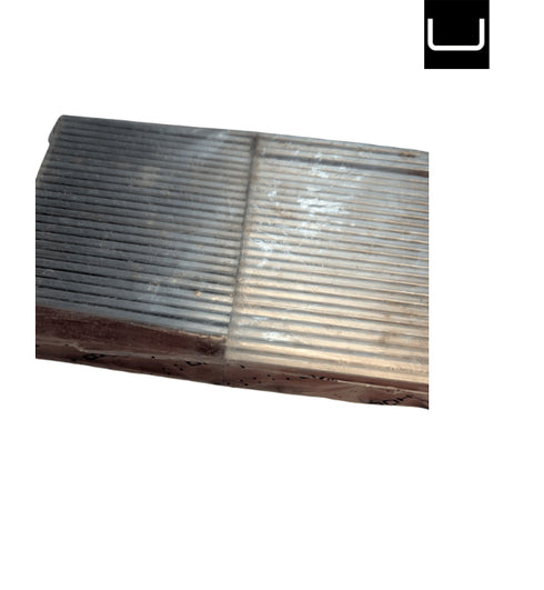 Metallic surface with a textured pattern on a white background