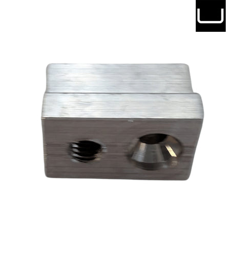 Metallic block with two cylindrical holes on a white background