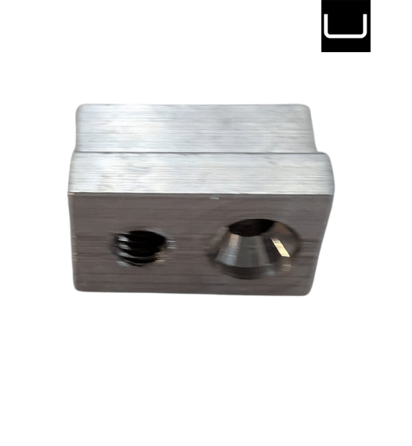 Metallic block with two cylindrical holes on a white background