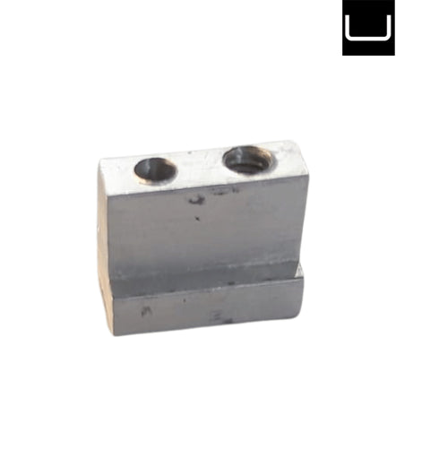 Metal block with two cylindrical holes on a white background