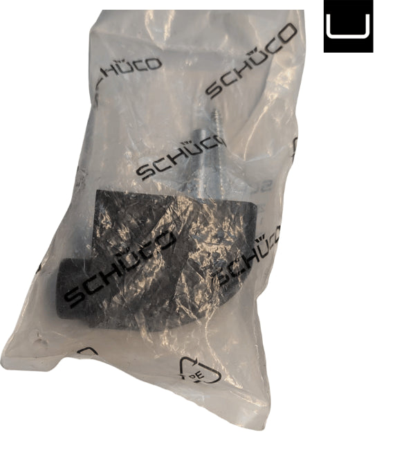 Black pads in a clear Schuco packaging bag on a white background