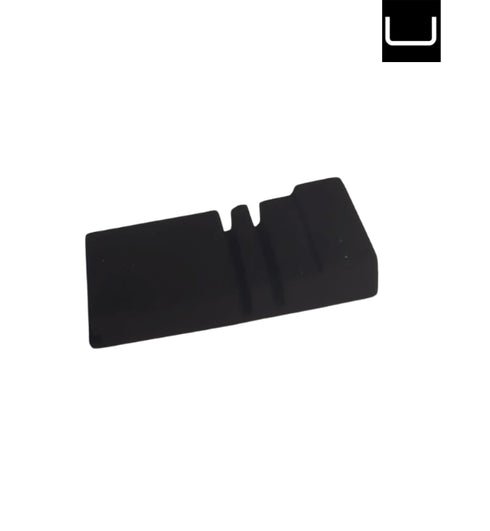 Black plastic component on a white background