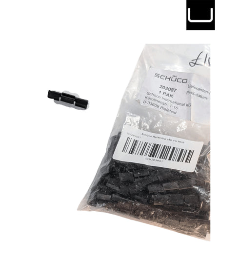 Bag of black plastic components with a Schuco label on a white background