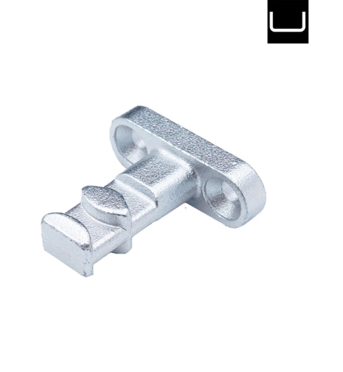 Metallic T-shaped component on a white background