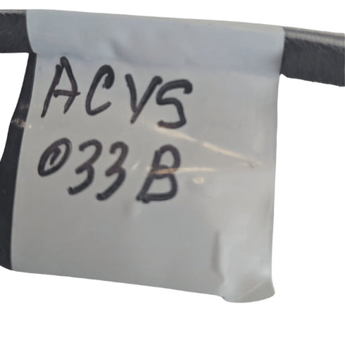 White label with 'ACVS 033 B' text on a metal surface