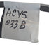 White label with 'ACVS 033 B' text on a metal surface